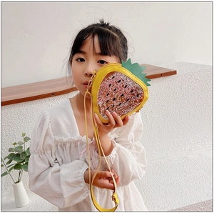 Detail of yellow strawberry shaped jelly bag featuring moving sequins and a PU leather strap