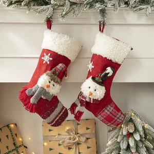 Red Christmas stockings with 3D snowman and snowflake embroidery on fireplace