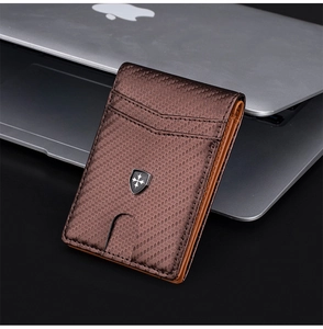 Brown carbon fiber wallet with card slots and a metal shield badge on a laptop