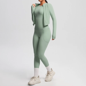 Detail of mint green yoga set featuring high-waist pocket leggings and a slim zip jacket