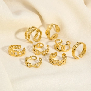 Detailed set of eight gold-plated minimalist rings and ear cuffs on yellow silk fabric