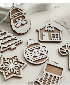 Close-up of wooden Christmas ornaments featuring snowflakes and reindeer patterns