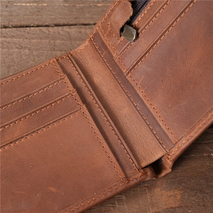 Close-up of brown vintage leather wallet interior with multiple card slots and zipper pocket