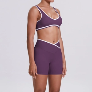 Detail view of purple yoga set with cross-waist shorts and contrast binding stitching