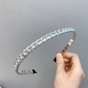 Close-up of a silver metal chain headband with polished links and protective end caps
