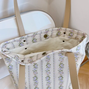 Detailed top view of floral canvas tote bag showing bronze magnetic snap and interior space