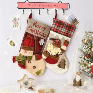 Detail of Christmas stockings with 3D Santa and Snowman hanging on a decorative hook