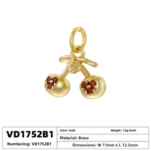 Detail of a brass cherry pendant with red gems and gold plating, size 11mm x 12.5mm