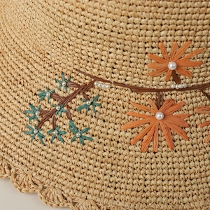 Handmade raffia straw sun hat with embroidered flowers and pearl details for women