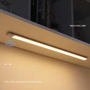 Ultra-thin motion sensor LED cabinet light with warm yellow glow on a shelf