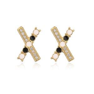 Detailed view of 18K gold plated X-shaped earrings with zircon and enamel inlays