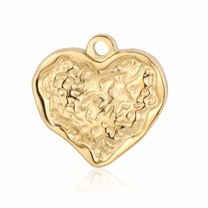 Detailed view of heart-shaped gold pendant with irregular hammered texture and metallic luster