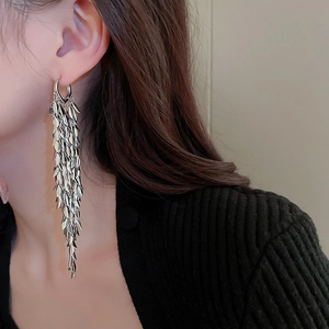 Silver leaf tassel long earrings on model showing fashion drop style and metallic shine