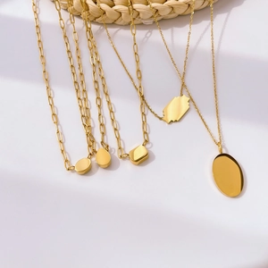 Detailed view of geometric 18K gold plated titanium necklaces with zircon pendants