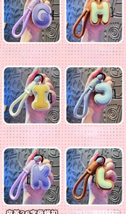 Macro shot of colorful faux leather alphabet keychains G to L with braided wristlet
