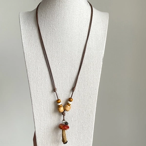Handmade wooden bead necklace with a realistic red mushroom pendant and adjustable wax cord