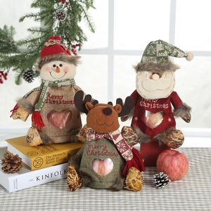 Detailed view of Christmas gift bags featuring snowman and reindeer with heart window