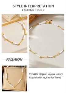 Detailed view of oval pearls and gold tube links on a luxury stainless steel necklace