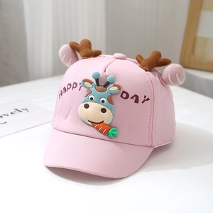 Detail of pink cotton baby cap featuring 3D cartoon giraffe and plush deer antlers
