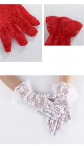 Close-up of floral lace texture and ruffled wrist cuffs on elegant summer sun gloves