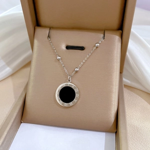 Silver titanium steel necklace with black roman numeral pendant on white silk