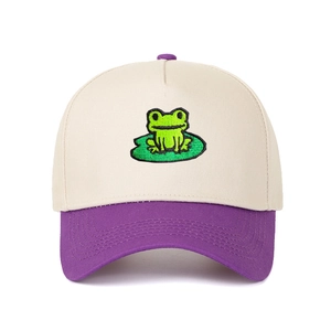 Two-tone trucker hat in cream and purple featuring frog and lotus leaf embroidery
