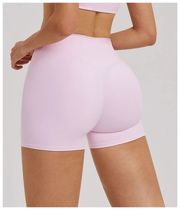 Detail view of pink high-waisted yoga shorts with V-shaped back seam and booty lifting cut