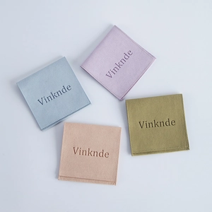 Velvet jewelry envelope pouches in blue, purple, beige, and green with embossed logos