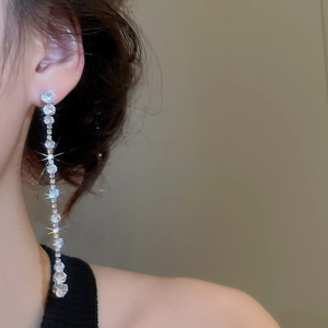 Detailed view of silver dangle earrings featuring sparkling teardrop cubic zirconia stones