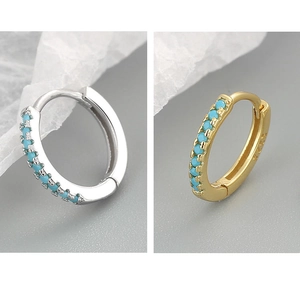 Detailed close-up of gold and silver turquoise huggie earrings with S925 engraving