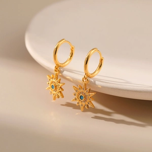 Golden sunburst huggie earrings with sky blue zircon stones and micro-pave crystals