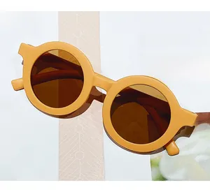 Detail view of round frame yellow sunglasses on a magazine for kids fashion