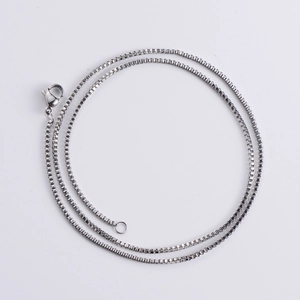 Close-up of silver stainless steel box chain necklace with a secure lobster clasp closure