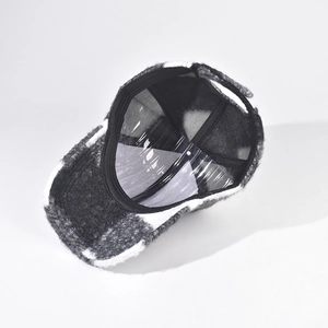 Detail of classic black and white plaid winter baseball cap with mesh lining and adjustable strap