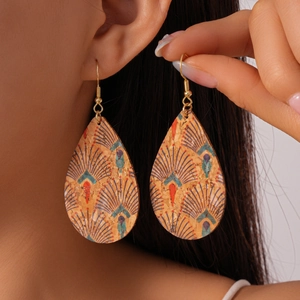 Bohemian cork teardrop earrings with peacock pattern on model showing ethnic style and size