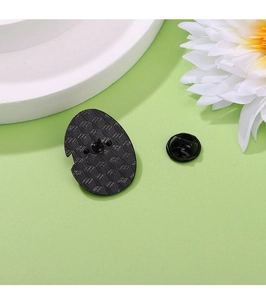 Detailed view of the black metal back with cross-grid texture and secure pin clutch