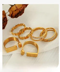 Close-up of vintage gold-plated titanium rings set featuring floral and hollow heart designs