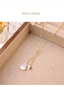Close-up of 18k gold plated titanium necklace with lavender gourd and crystal heart pendants