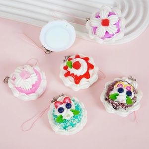 Miniature faux cake charms in pink and blue for bags, featuring fruit and cream toppers