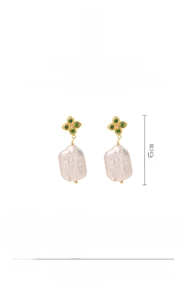 Detail view of gold clover earrings with green gemstone and white baroque pearls