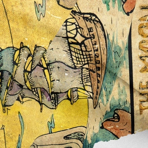 Detail of vintage bohemian tapestry showing fabric texture and The Moon tarot print