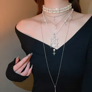 Elegant multi-layer crystal pearl necklace set with cross pendants on female model