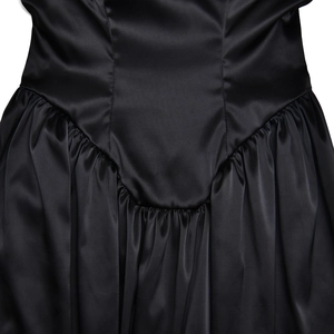 Detail of black satin fabric showing the sleek pleated design and waist stitching