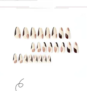 Detail of almond-shaped press-on nails featuring vintage brown and white wave patterns