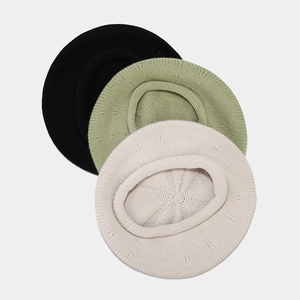 Detailed knit texture of minimalist beret hats in black, matcha green, and beige white