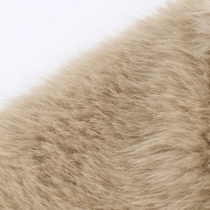 Close-up of soft light brown faux fur texture and delicate fibers on the short jacket