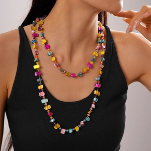 Close-up of bohemian multilayer necklace with colorful irregular beads on model