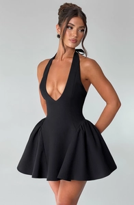 Detailed view of black deep V-neck halter mini dress with fitted waist and flared hemline