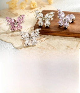 Macro detail of butterfly cartilage stud earring featuring marquise-cut zircon stones