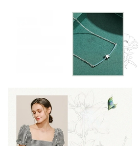 Detailed view of S925 silver star necklace featuring blue turquoise and curved pendant design